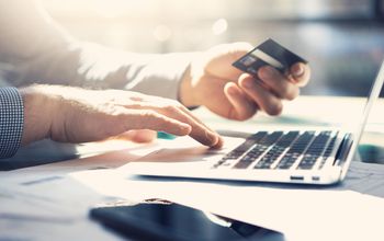 Man on laptop with credit card
