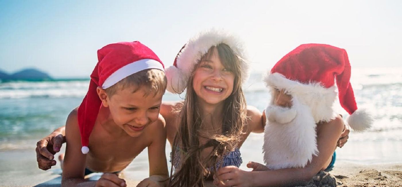 Image: Kids celebrating Christmas on the beach. (photo via Princess Hotels & Resorts)