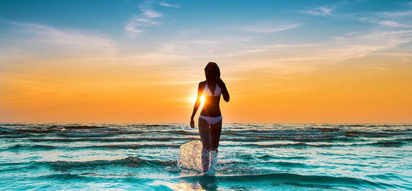 Image: PHOTO: Woman in bikini on the beach during sunset. (photo via Flickr/Tung Hoang)
