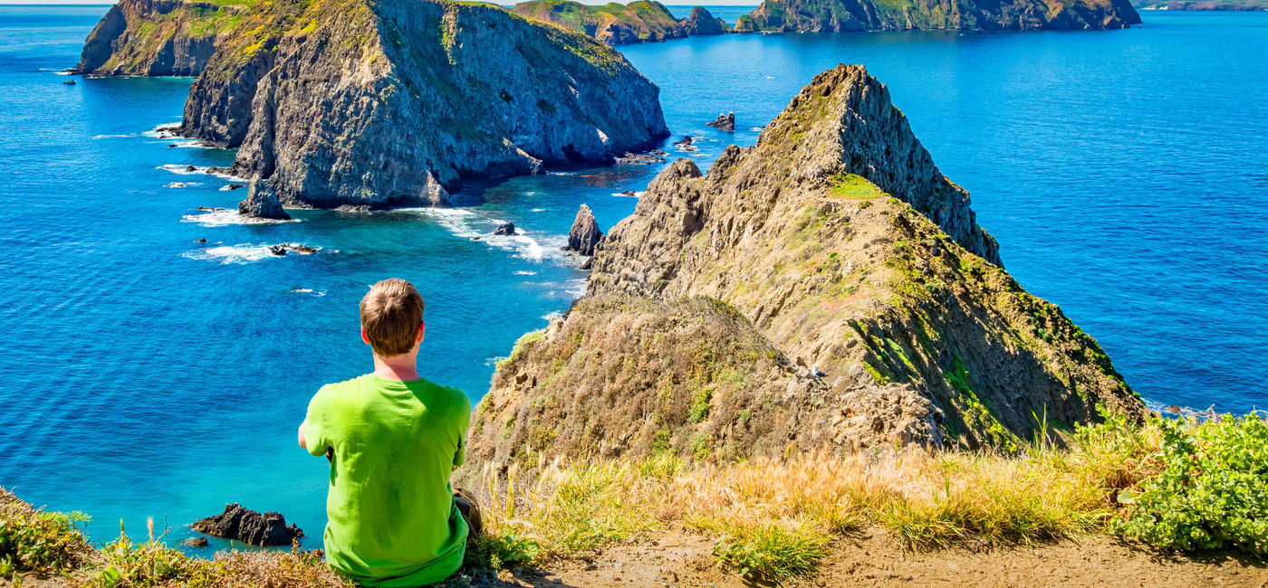Image: A hiker takes in the view from Anacapa Island, Channel Islands National Park, California. (photo via iStock/Getty Images Plus/benedek)
