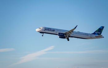 A JetBlue flight taking off from LAX A JetBlue flight taking off from LAX