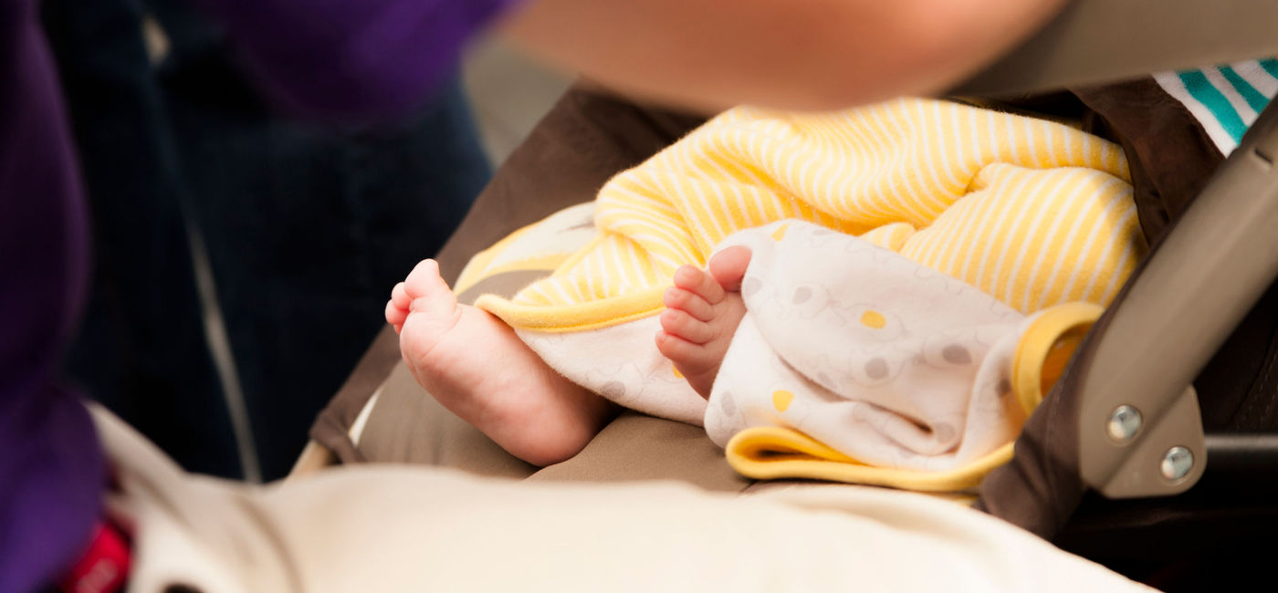 Image: Tiny baby's feet peek out from under her blanket (Photo via  fstop123 / iStock / Getty Images Plus)