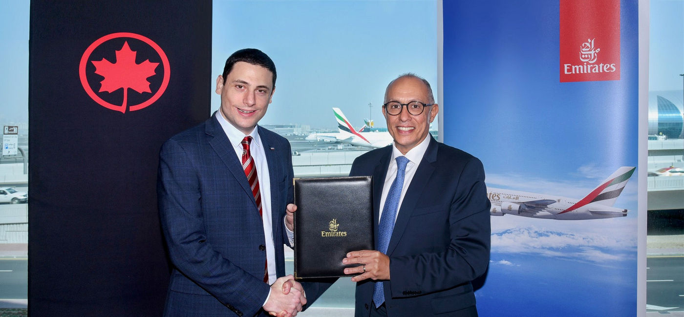 Image: Emirates and Air Canada have expanded their partnership to offer frequent flyer members joint loyalty programme benefits. The agreement was signed by Dr. Nejib Ben Khedher, Divisional Senior Vice President Emirates Skywards (right) and Mark Youssef Nasr, Senior Vice President, Product, Marketing, e-Commerce, Air Canada and President, Aeroplan (left). (Emirates)