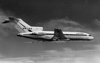 Three engine T-tailed jetliner in black and white