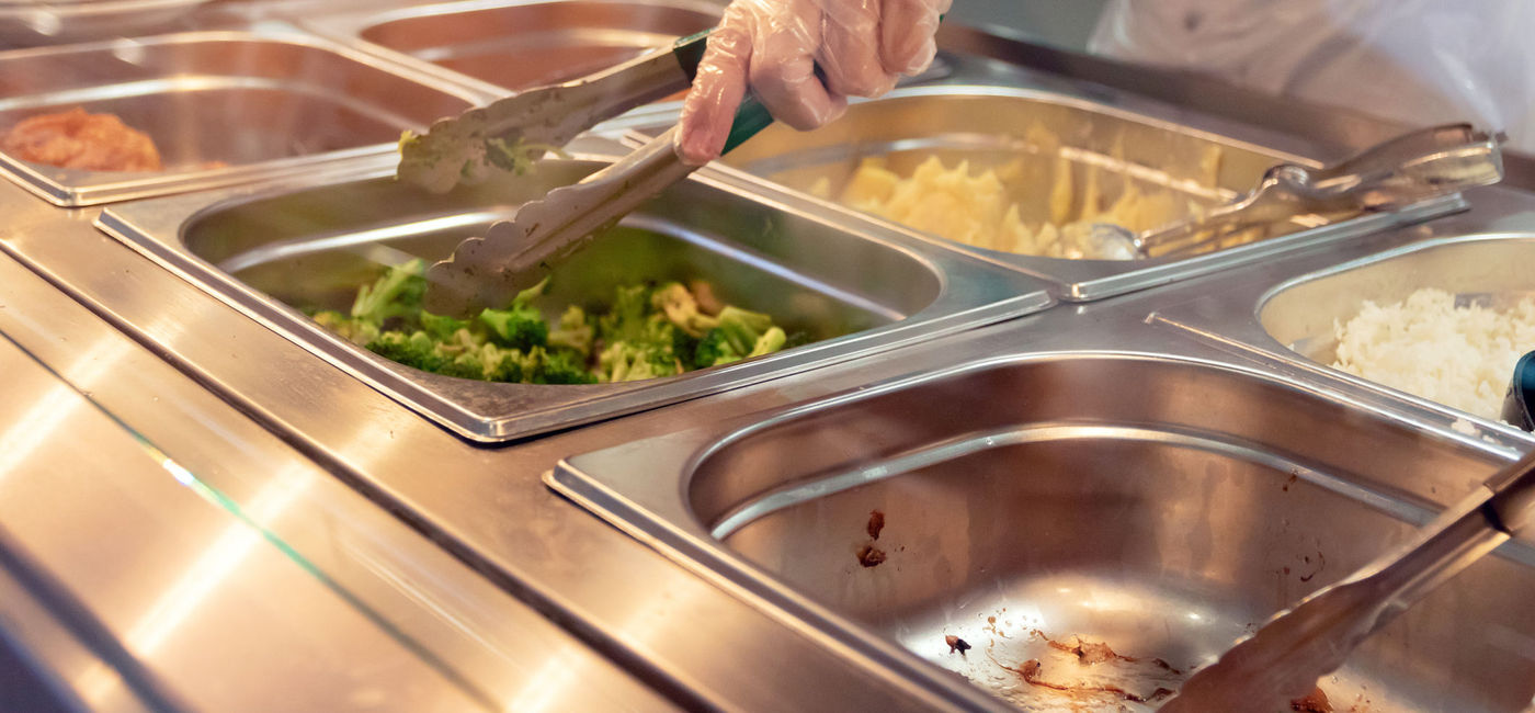 Image: PHOTO: Chef serving food from a buffet. (photo via PJjaruwan/iStock/Getty Images Plus)