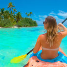 Woman kayaking during her vacation in the Cook Islands. 