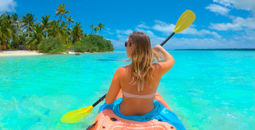 Woman kayaking during her vacation in the Cook Islands. 