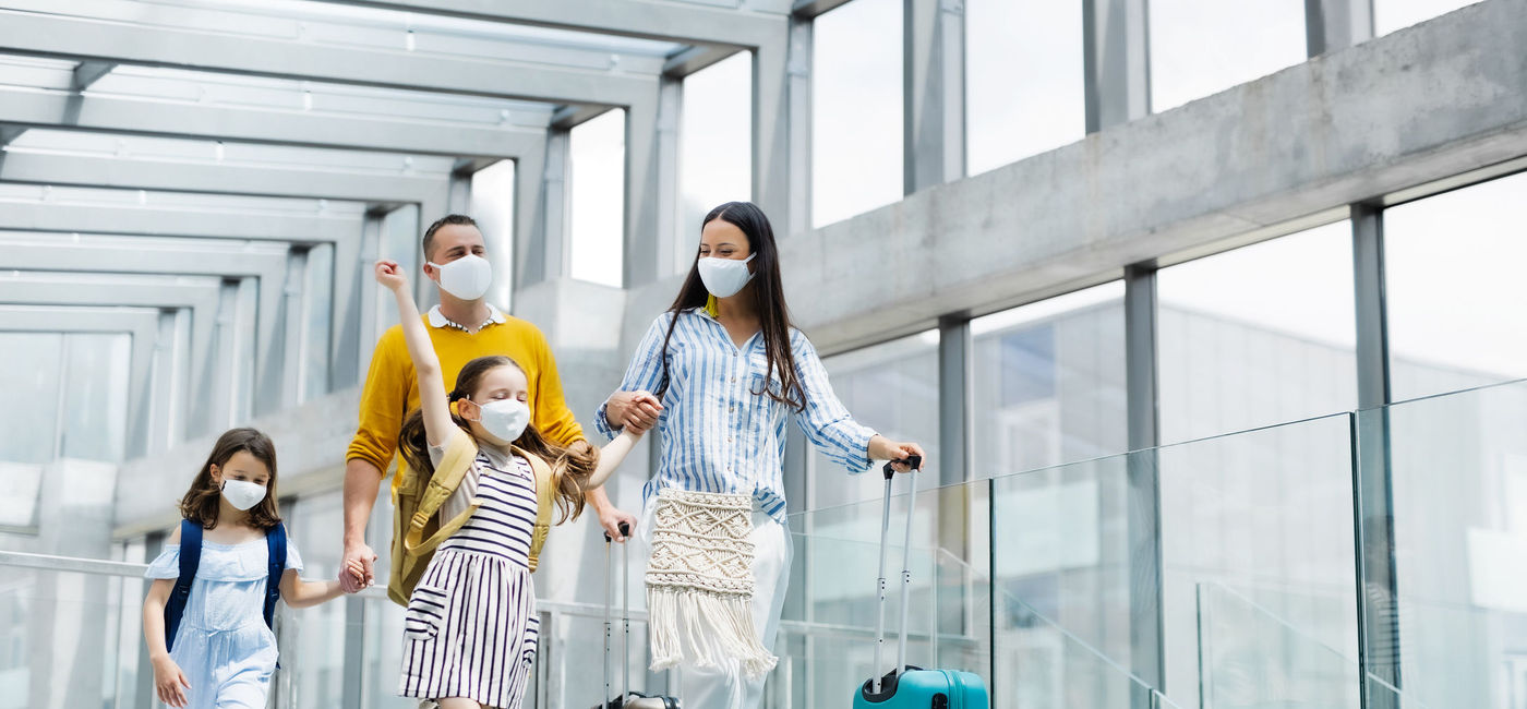 Image: Family with two children going on holiday. (photo via Halfpoint / iStock / Getty Images Plus)