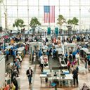 People traveling through security to the gates of Denver International Airport