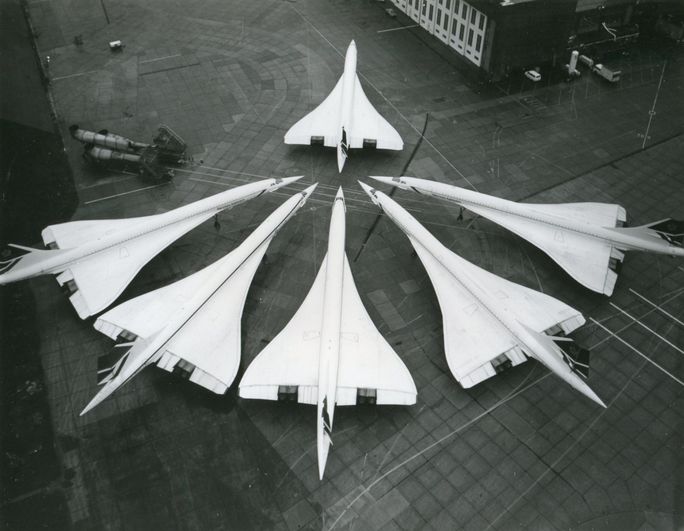 Six concorde aircraft in formation on the grount.
