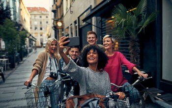 Friends Riding Bicycles In A City