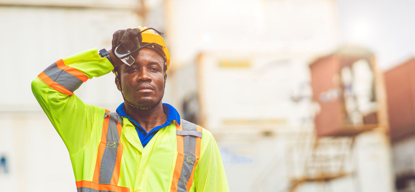 Image: Airport ground crew worker sweating in the extreme outdoor heat. (Source: iStock/Getty Images Plus/coffeekai)