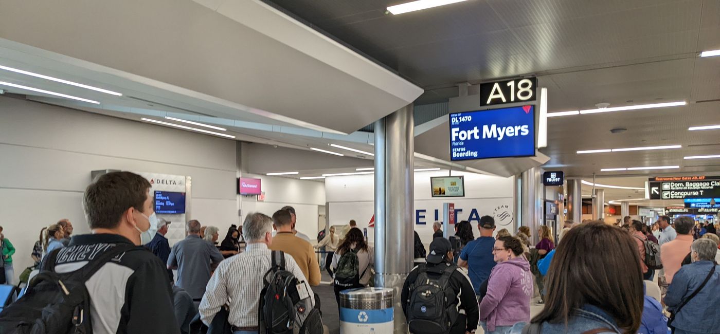Image: A crowd of people waiting to board the plane. (photo by Eric Bowman)