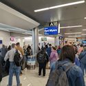 Airport crowd gathers at gate to board flight
