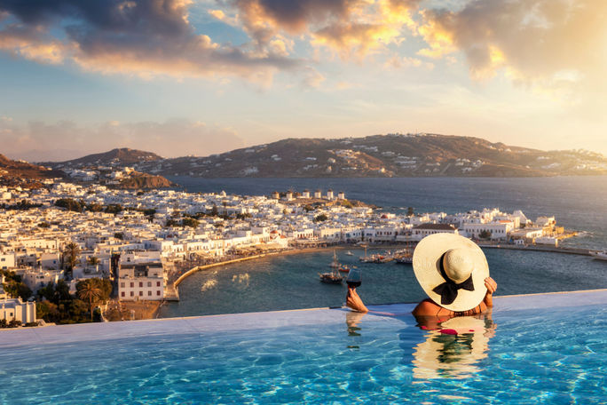 Luxury travel, luxury travelers, infinity pool, wine, Mykonos, Greece