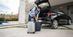 Traveler packing a rental car