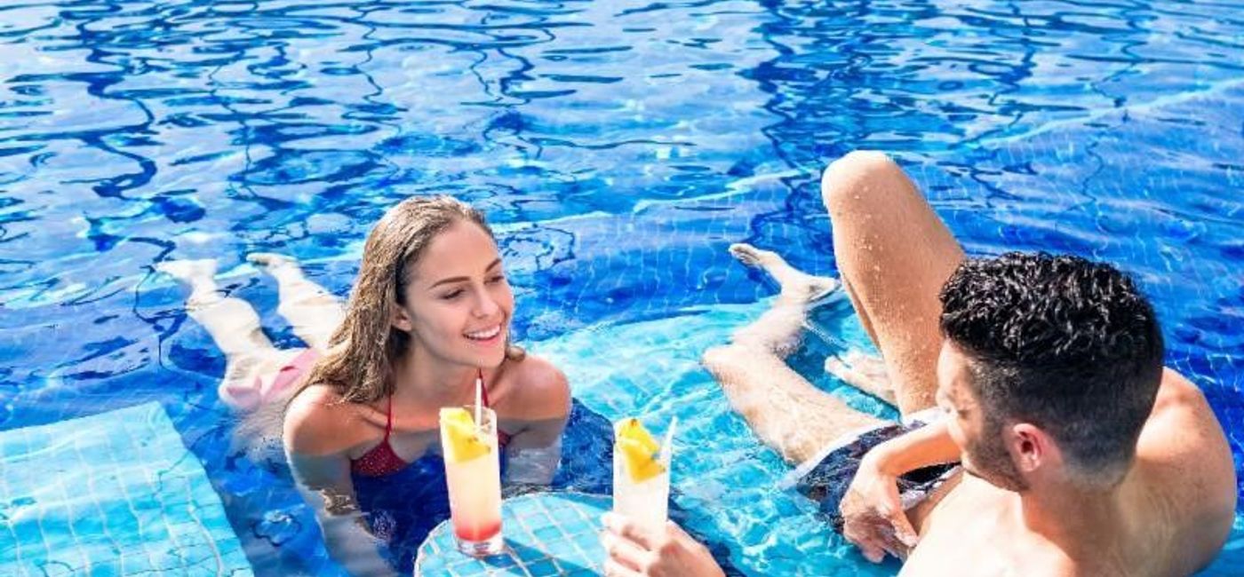 Image: PHOTO: A couple relaxes at the pool (photo courtesy of Barceló Hotel Group) 