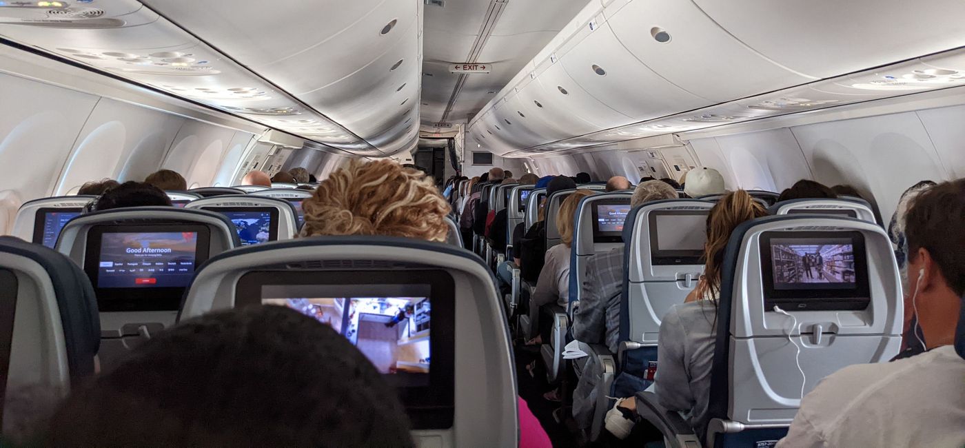 Image: Passengers seated inside a Delta airplane. (photo by Eric Bowman)