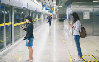 Travelers wearing masks in subway.