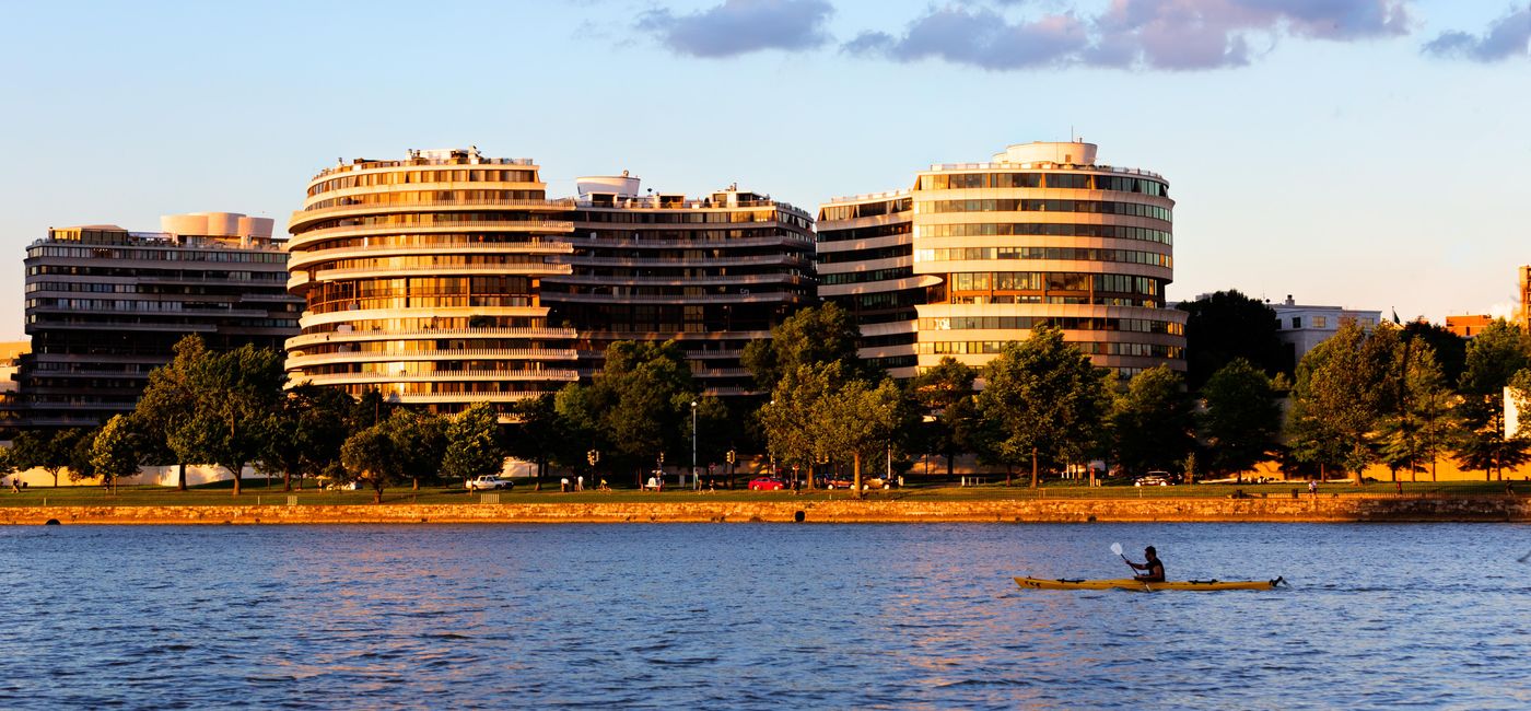 Image: PHOTO: The Watergate Hotel in Washington, DC with the Potomac River in the foreground. (photo via BrianPIrwin/iStock Editorial/Getty Images Plus)