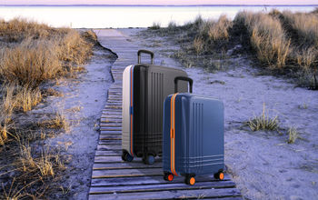 Roam Custom Color Luggage on a beach boardwalk