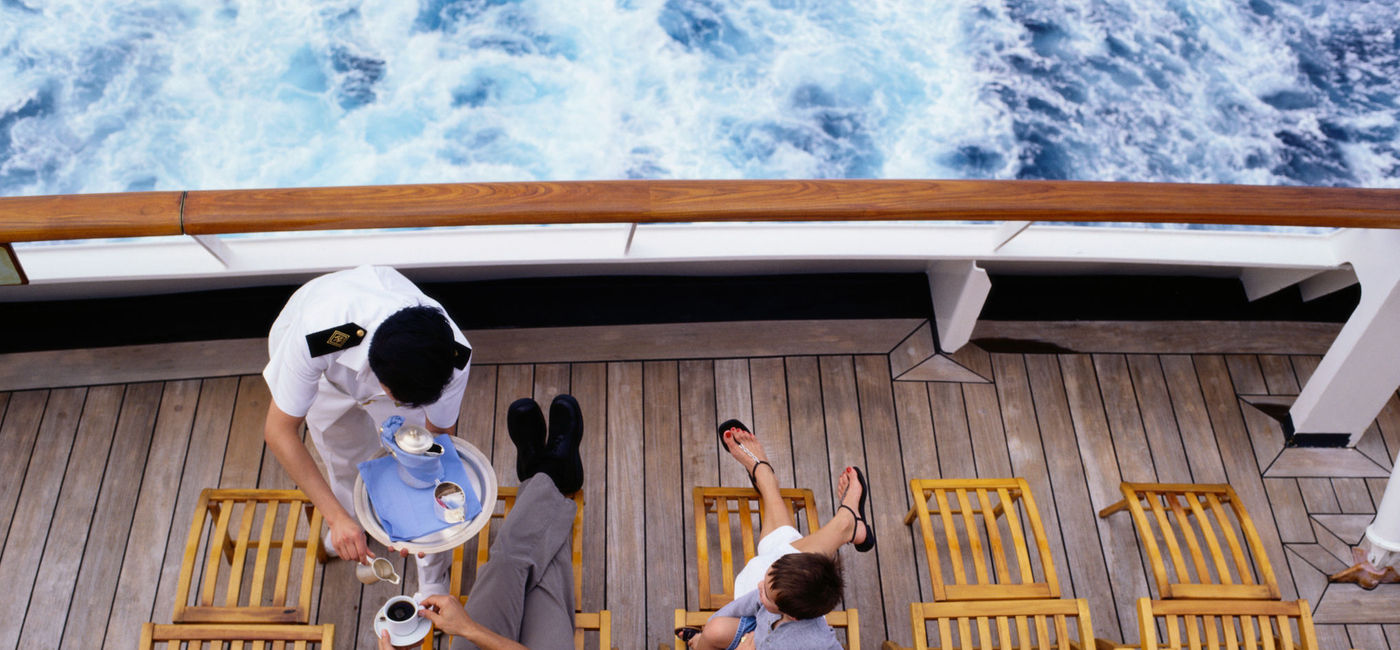Image: Family on cruise ship. (photo via Steve Mason / Photodisc)