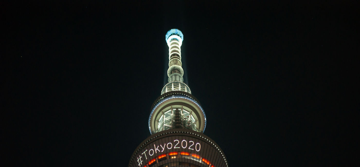 Image: The skytree tower is illuminated at night announcing the Olympics of Tokyo 2020 (photo via Joel Papalini / iStock Editorial / Getty Images Plus)