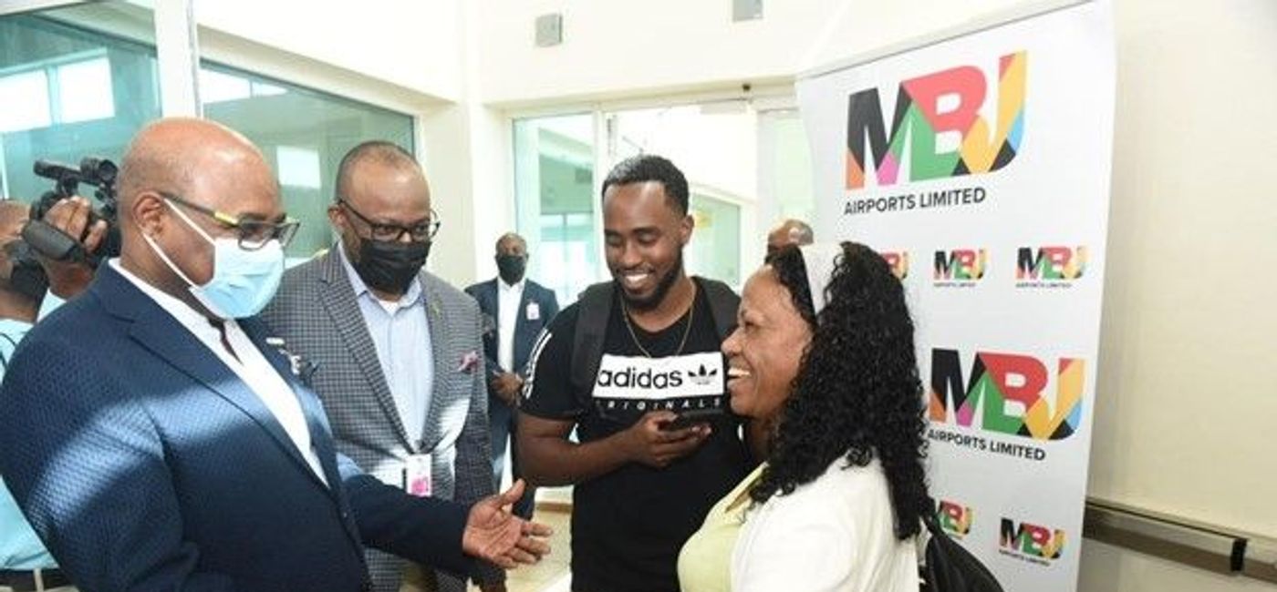 Image: Edmund Bartlett, Jamaica's tourism minister (left), joins Donovan White, director of tourism at the Jamaica Tourist Board, to greet Brian Simmons (second from right), as he becomes Jamaica's one- millionth 2022 visitor (with his mother, Monica Simmons). (Photo courtesy of the Jamaica Tourist Board).