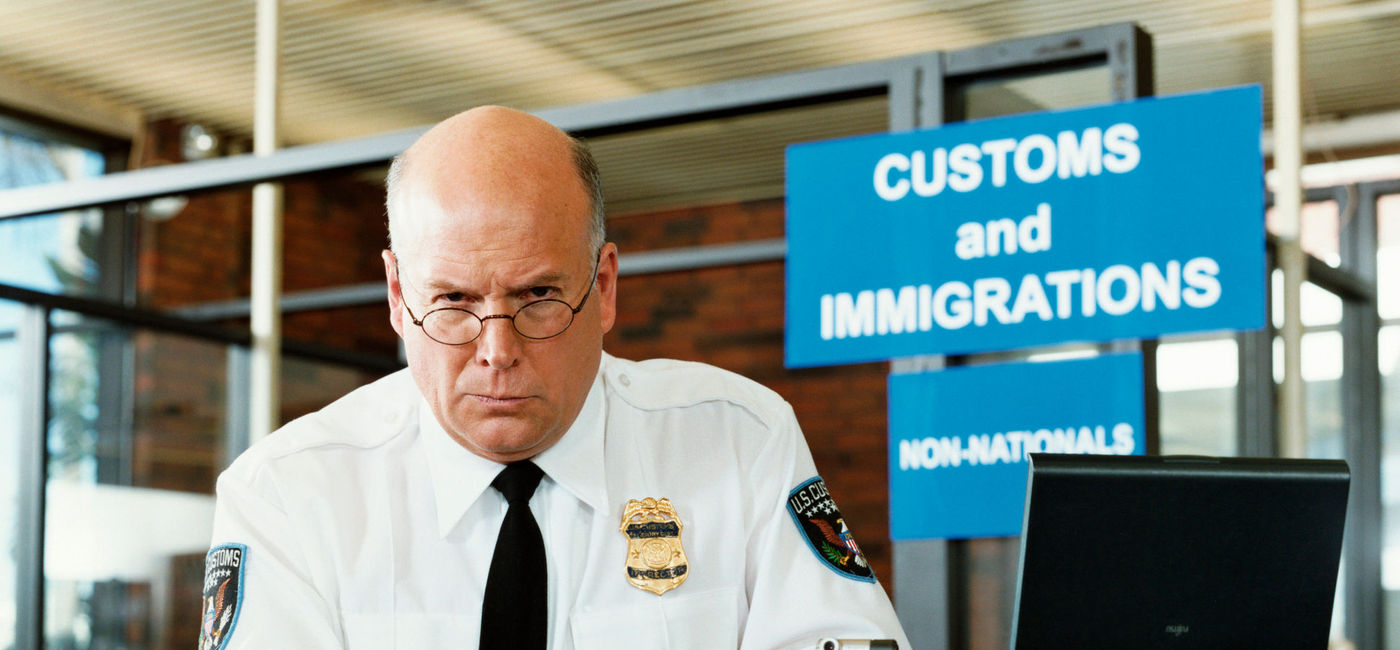 Image: An airport Customs and Border Protection agent. (Photo via iStock/Getty Images/Digital Vision.)
