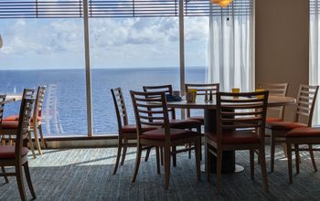 Indoor dining tables on Carnival Mardi Gras cruise ship