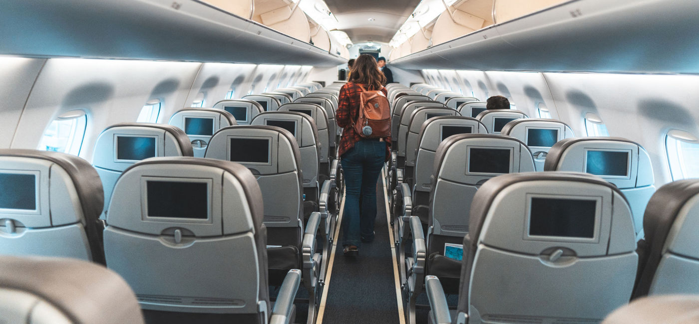 Image: Woman exiting an airplane. (photo via MesquitaFMS/E+)