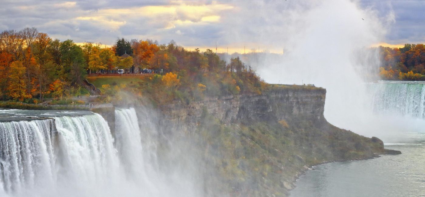 Image: PHOTO: Beautiful fall colors on the cliff of American Falls of Niagara Falls on the New York side (Photo via Orchidpoet/iStock/Getty Images Plus)