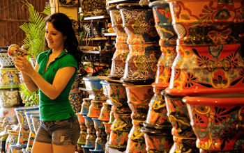 A woman browses locally made painted pottery in Guanajuato