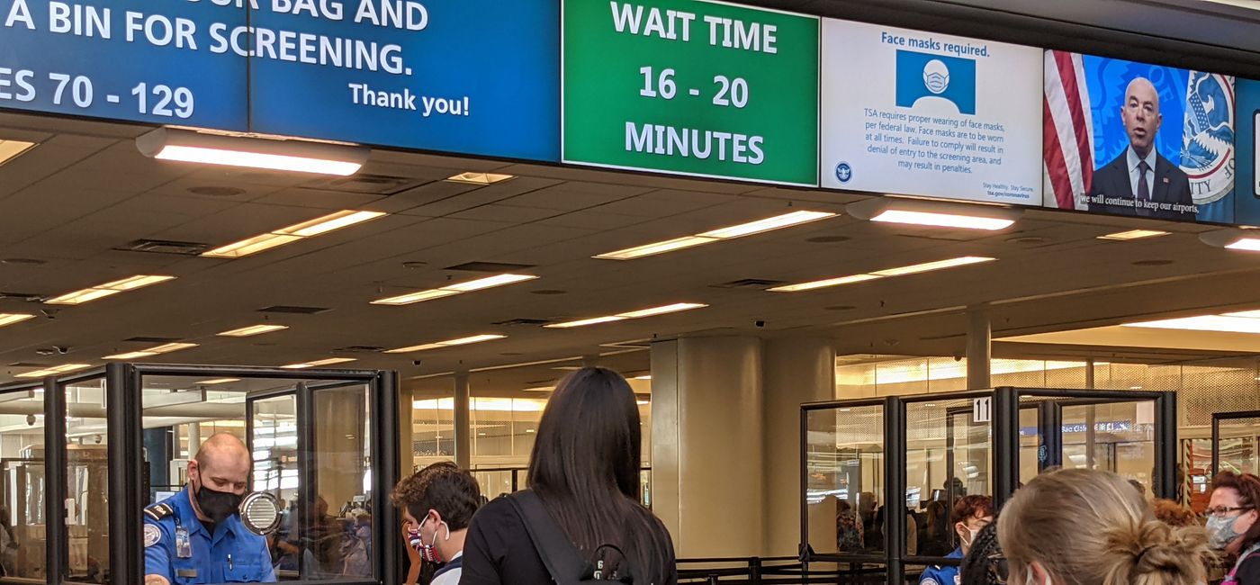 Image: Travelers wait to check in with TSA agent (photo by Eric Bowman)