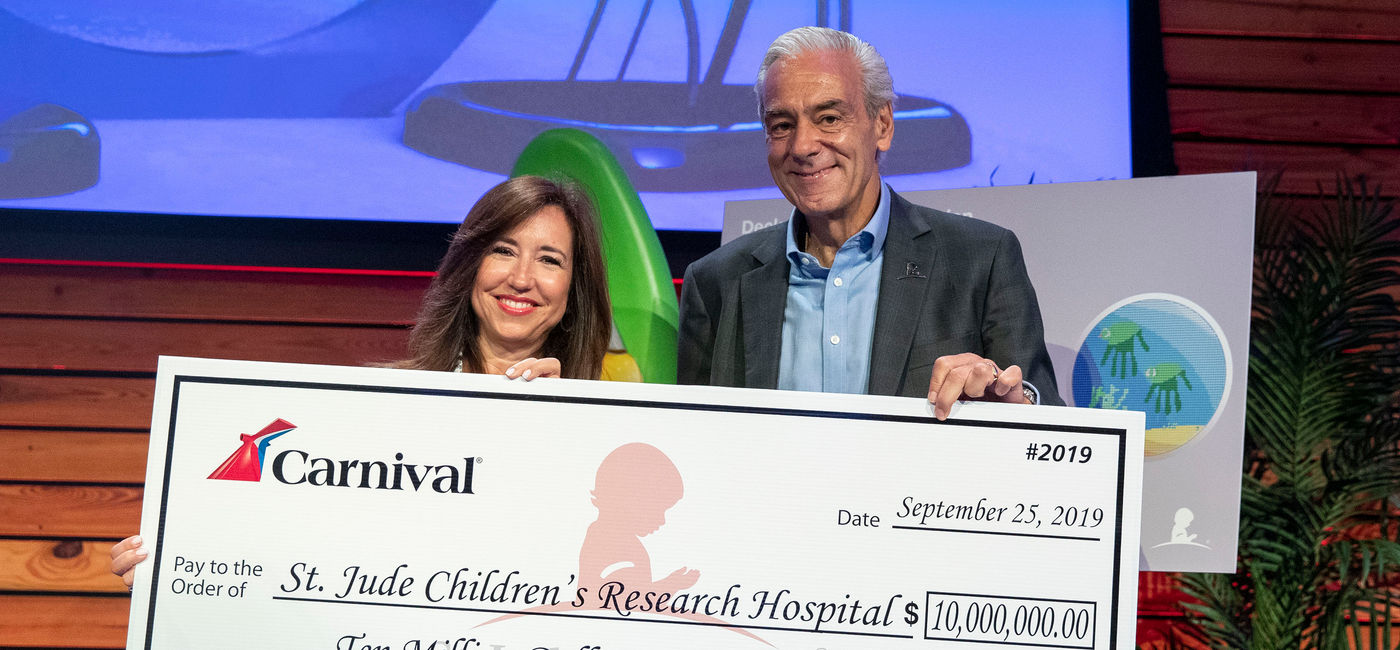 Image: PHOTO: Christine Duffy presents ALSAC’s Richard Shadyac, Jr. with a  check for $10 million at St. Jude Children's Research Hospital. (Photo courtesy of Carnival Cruise Line)