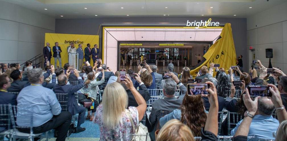 Brightline officials and local dignitaries watch as the Brightline Orlando Station is unveiled