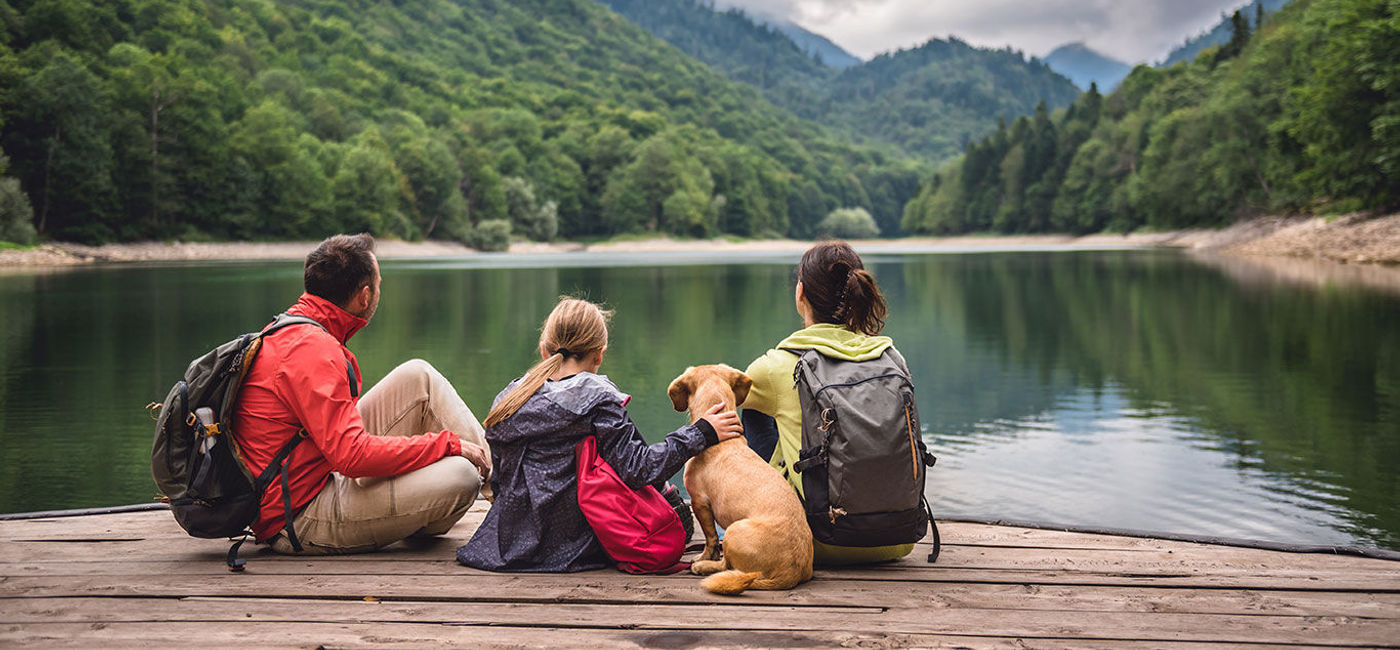 Image: Family with a dog resting on a pier. (photo iva  Kerkez / iStock / Getty Images Plus)