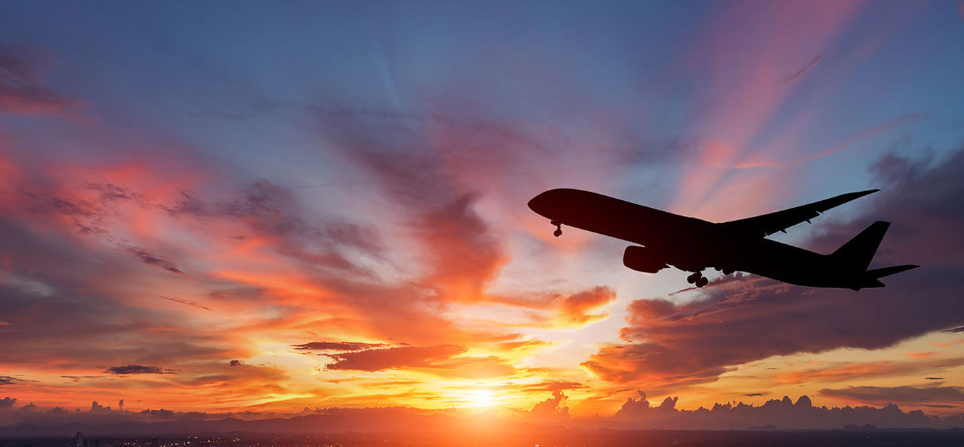 Image: The silhouette of a passenger plane flying in sunset. (Photo via manop1984 / iStock / Getty Images Plus)