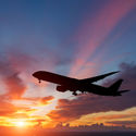 The silhouette of a passenger plane flying in sunset. (Photo via manop1984 / iStock / Getty Images Plus)