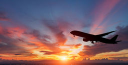 The silhouette of a passenger plane flying in sunset. (Photo via manop1984 / iStock / Getty Images Plus)