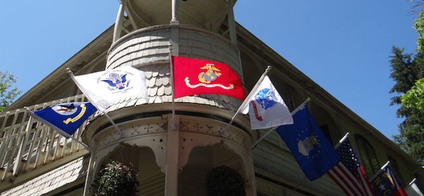 Image: PHOTO: Engadine Inn & Cabins flying service flags from various branches of the US Armed Forces. (photo courtesy of Engadine Inn & Cabins)