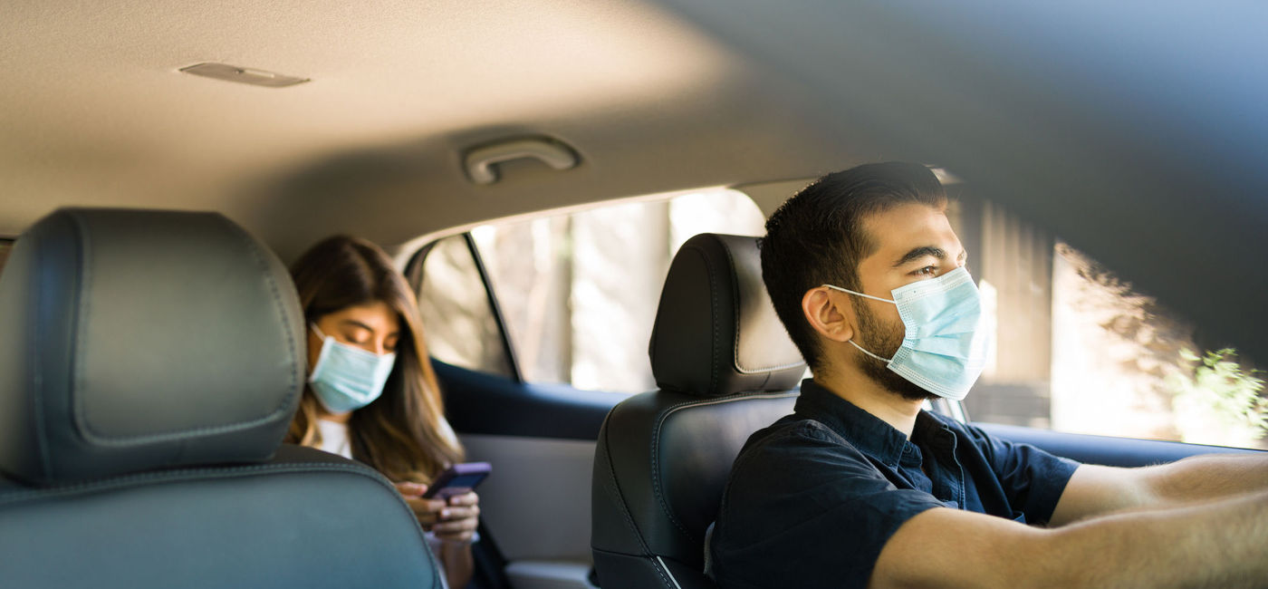 Image: A driver and passenger using a ride-hailing provider. (photo via Antonio_Diaz / iStock / Getty Images Plus)