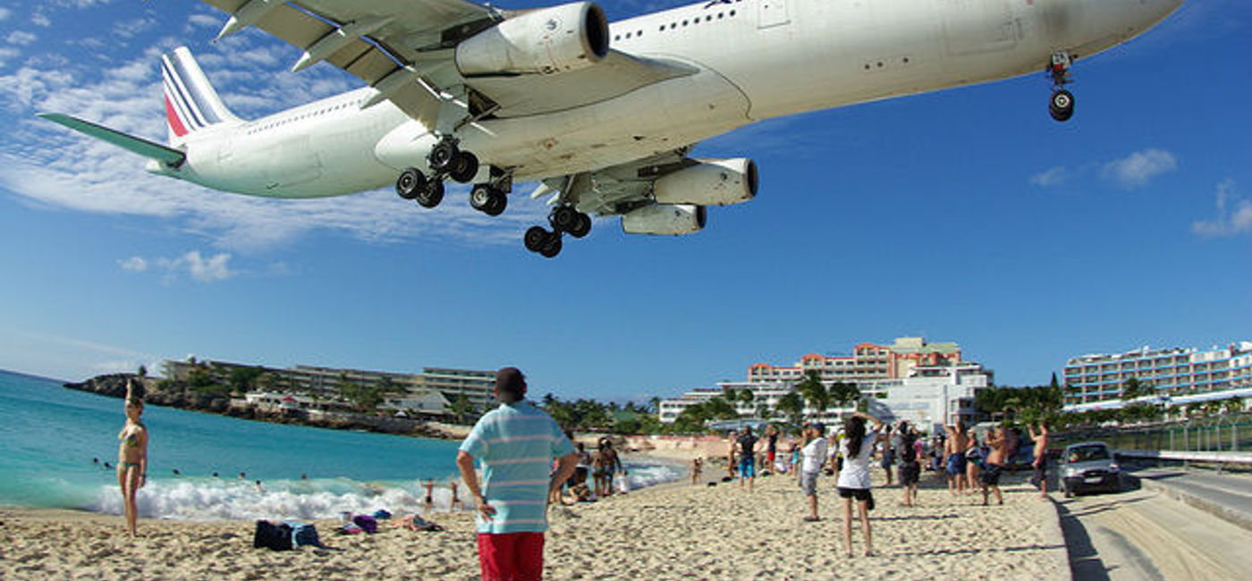 Image: PHOTO: Reach out and touch something at Maho Beach, St. Maarten. Courtesy Flickr/Takashi Ota) 
