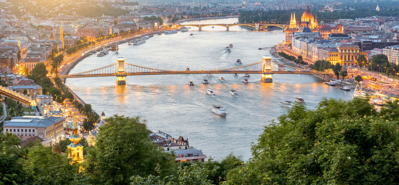 Image: PHOTO: Danube River with boats. (photo via RossHelen / iStock / Getty Images Plus)