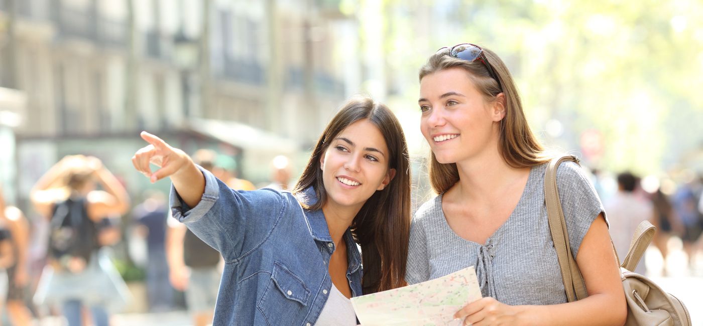 Image: A tourist getting directions. (photo via AntonioGuillem / iStock / Getty Images Plus)