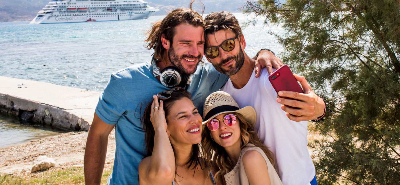 Image: Two couples take a selfie in front of a Celestyal Cruises ship. (photo via Celestyal Cruises) ((photo via Celestyal Cruises))