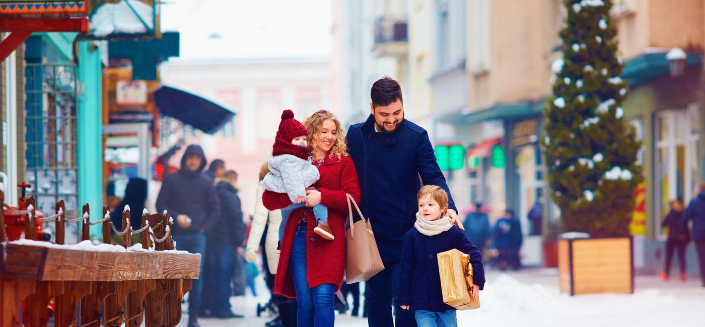 Image: Family walking together during the holidays. (photo via olesiabilkei/iStock/Getty Images Plus)
