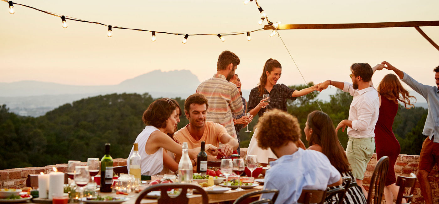 Image: Friends enjoying at patio during a social gathering (Morsa Images / Getty Images)
