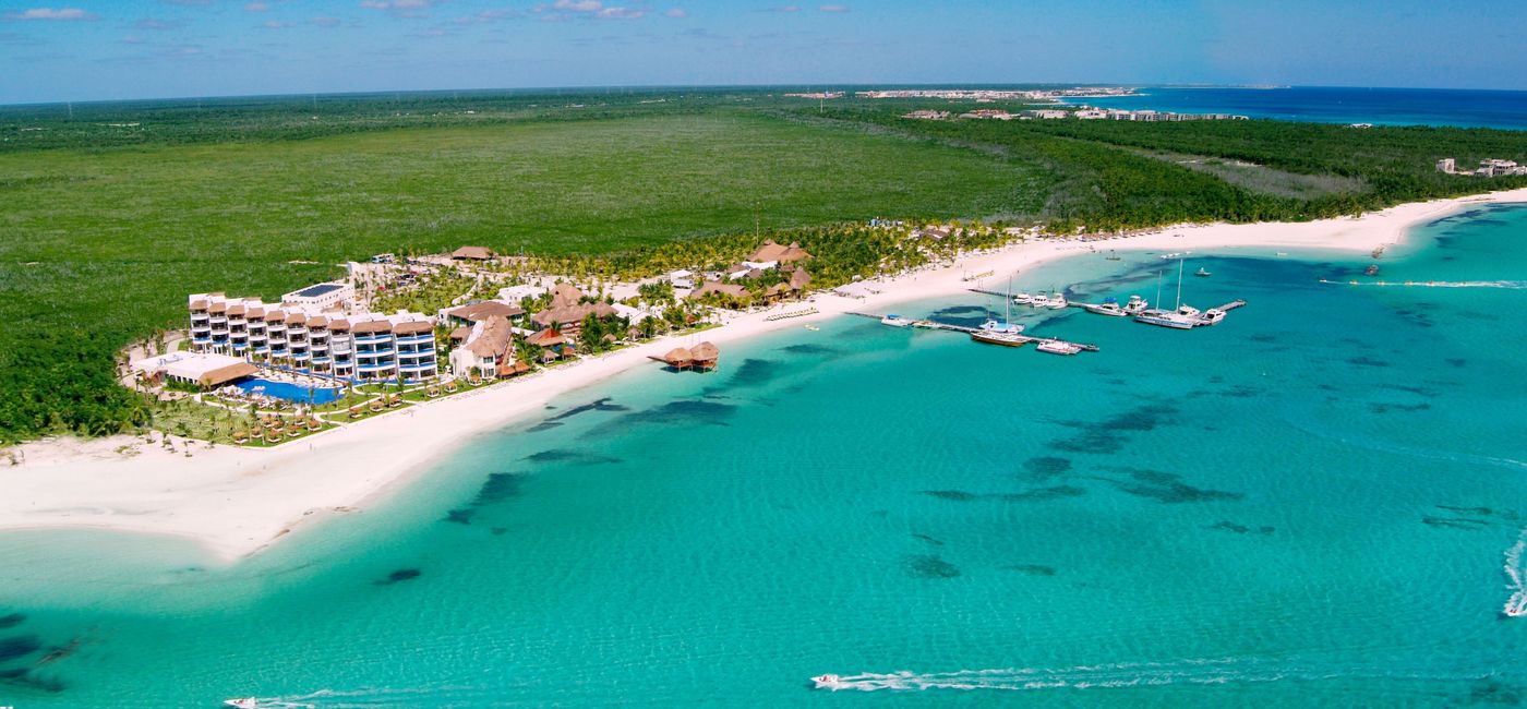 Image: In Playa Maroma, couples relax on white sandy beaches and watch stunning sunsets. (Photo via Quintana Roo Tourism Board).