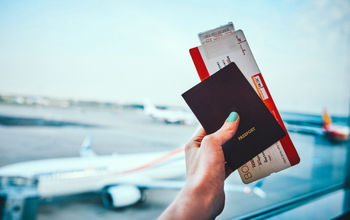 Passport and plane ticket before boarding plane.